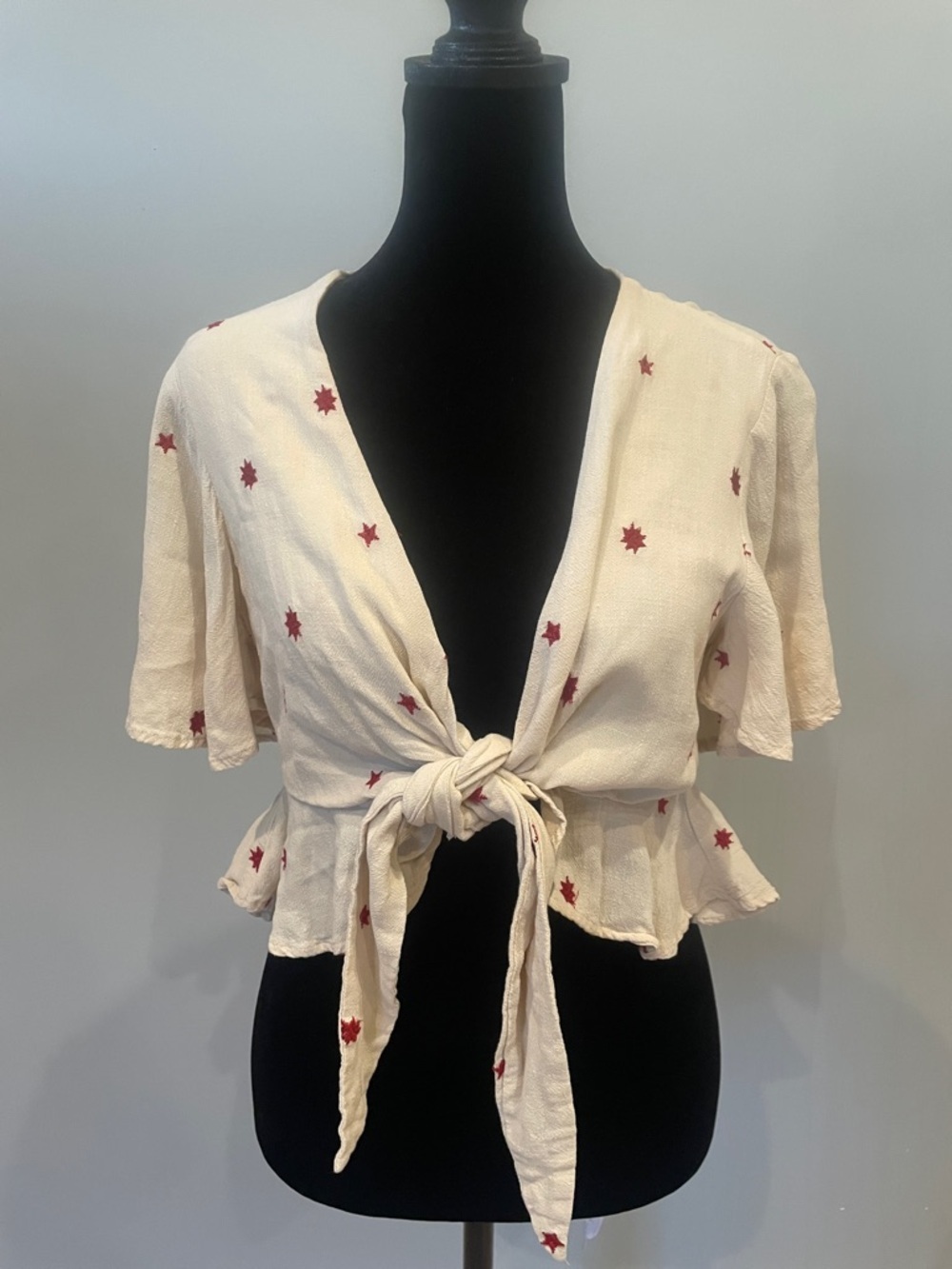 Cream Tie-Front Peplum Top with Red Star Print
